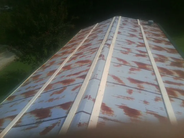 Rusted metal roof panels with new wood purlins before replacement — Storm Damage Roof Repair in Vincent by Roofing Brothers